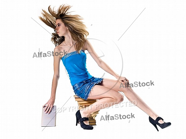 Blonde girl in blue dress wawing her hair