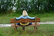 Blonde girl sitting on bench