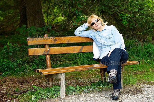 Blonde girl sitting on bench
