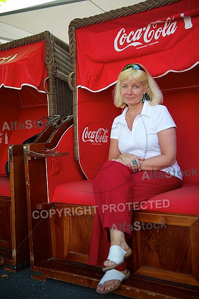 Blonde girl sitting on bench