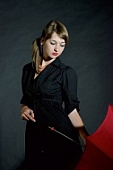 Modell girl posing with red umbrella