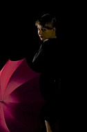 Modell girl posing with red umbrella