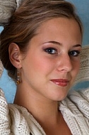 Portrait of a girl with brown hair and white sleeves