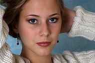 Portrait of a girl with brown hair and white sleeves