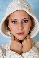 Portrait of a girl with brown hair and white sleeves