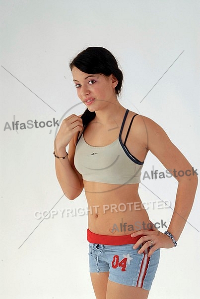 Woman with black hair in light top  and shorts
