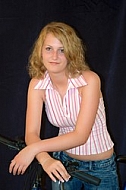 Woman with blonde hair in pink shirt and jeans