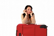 Young girl packs her bags for traveling. White background