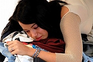 Young girl packs her bags for traveling. White background