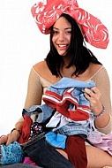 Young girl packs her bags for traveling. White background