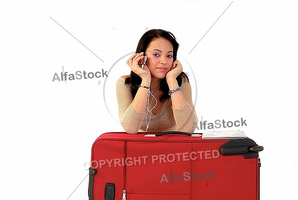 Young girl packs her bags for traveling. White background