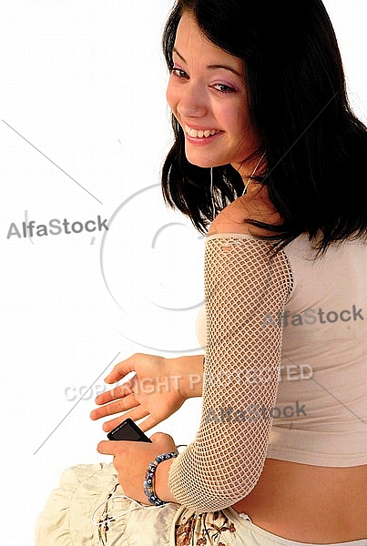 Young girl packs her bags for traveling. White background