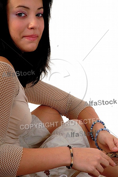 Young girl packs her bags for traveling. White background