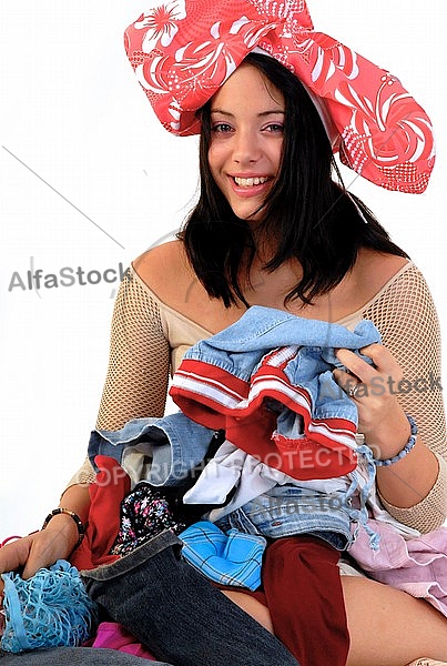 Young girl packs her bags for traveling. White background