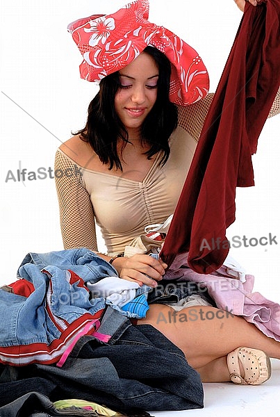 Young girl packs her bags for traveling. White background