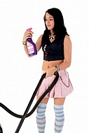 Yung girl with vacuum cleaner. White background