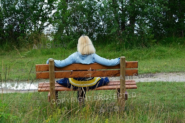 Blonde girl sitting on bench
