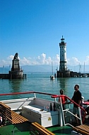 Boat with water and a cloc tower in the background, Lindau in Germany