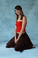 Girl in red top and brown skirt with brown hair