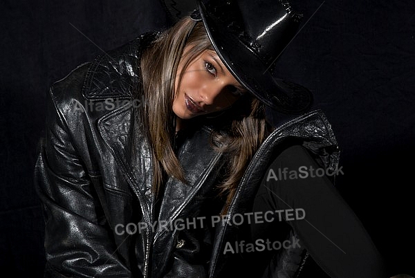 Girl with brown hair in black jacket and hat