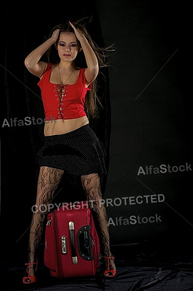 Girl with brown hair, red shirt and suitcase