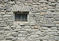 Old window by a simple stone.