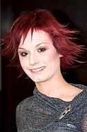 Woman with red hair and grey shirt