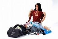 Young girl packs her bags for traveling. White background